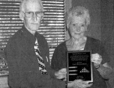 Sue (Denny) Richardson receiving a plaque of appreciation in memory of Earl Richardson